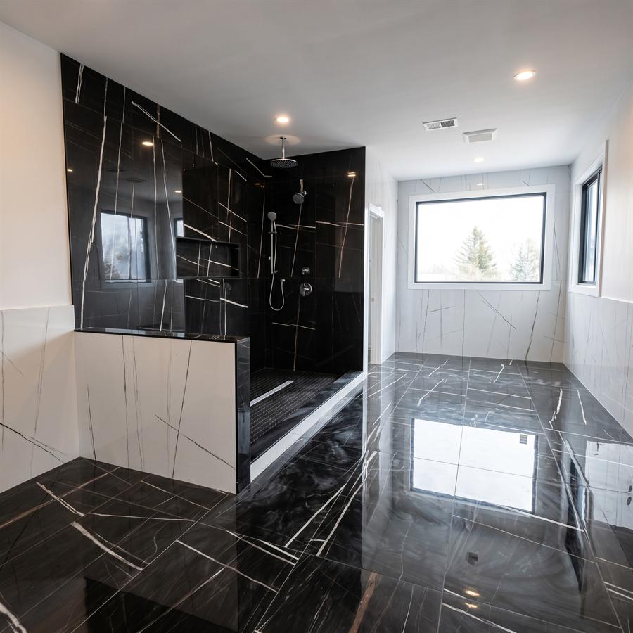 Black and white porcelain bathroom with glass shower enclosure, New Jersey