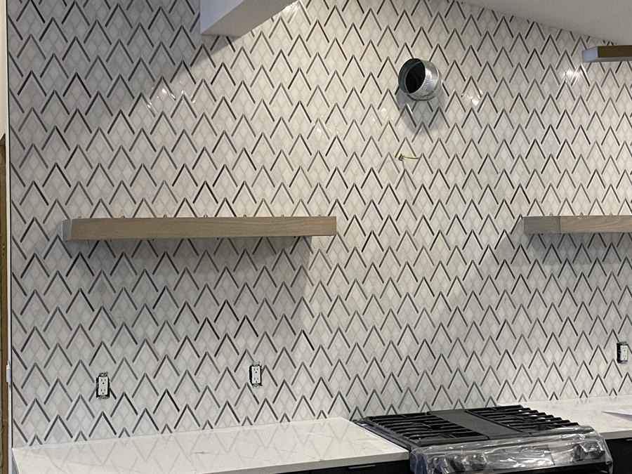 Herringbone porcelain backsplash with floating shelves, New Jersey