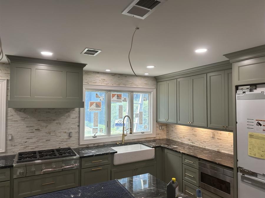 Sage green kitchen with porcelain slab backsplash, New Jersey