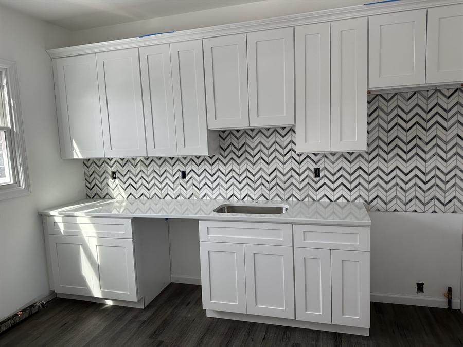 White kitchen with chevron porcelain mosaic backsplash installed by Silcam Tile in New Jersey
