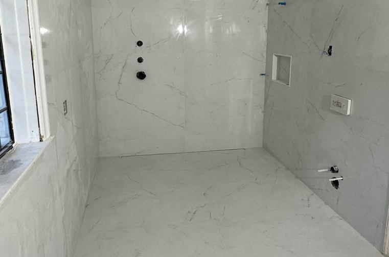 White porcelain walk-in shower with linear drain installed by Silcam Tile in New Jersey